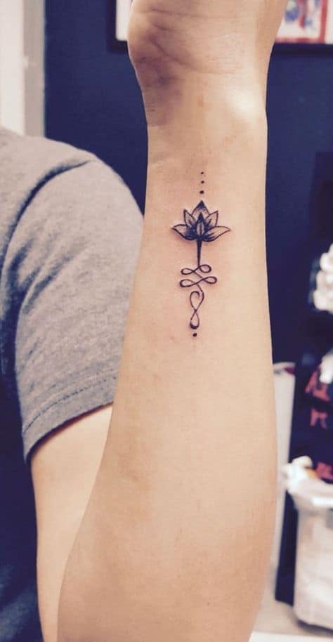 Unalome tattoo with a lotus on the forearm, symbolizing spiritual enlightenment, growth, and the journey to inner peace.