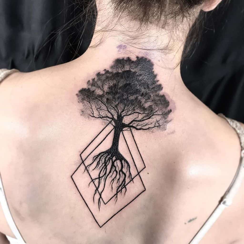The tattoo features an intricate Yggdrasil design, with a tree and roots inside a geometric diamond frame.