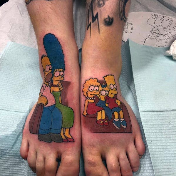 Colorful foot tattoos of The Simpsons family, with Homer and Marge on one foot and Bart, Lisa, and Maggie on the other.