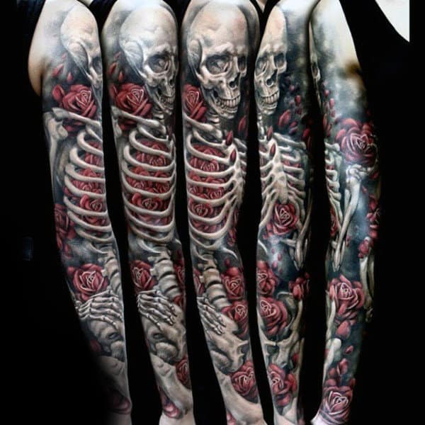 Detailed arm tattoo depicting skeletons and red roses