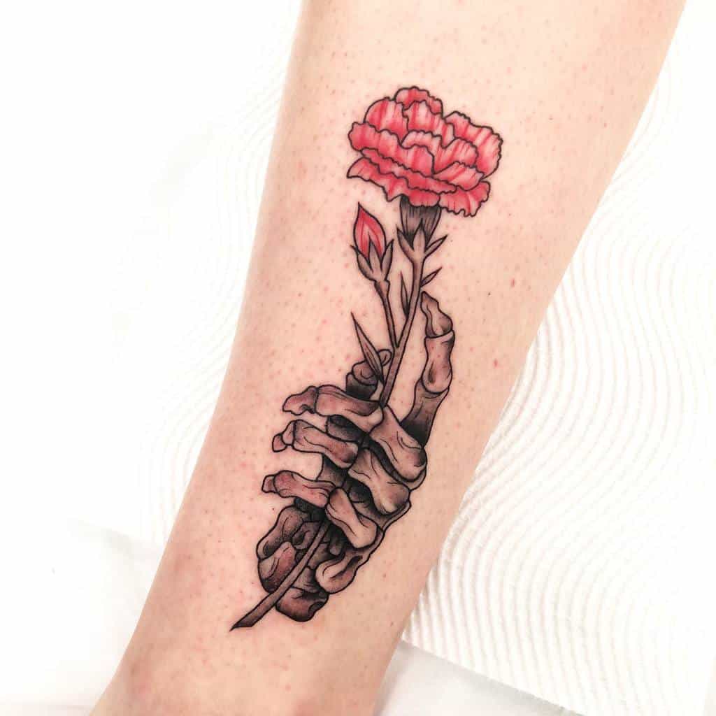 Tattoo of a skeletal hand holding a red carnation with a bud