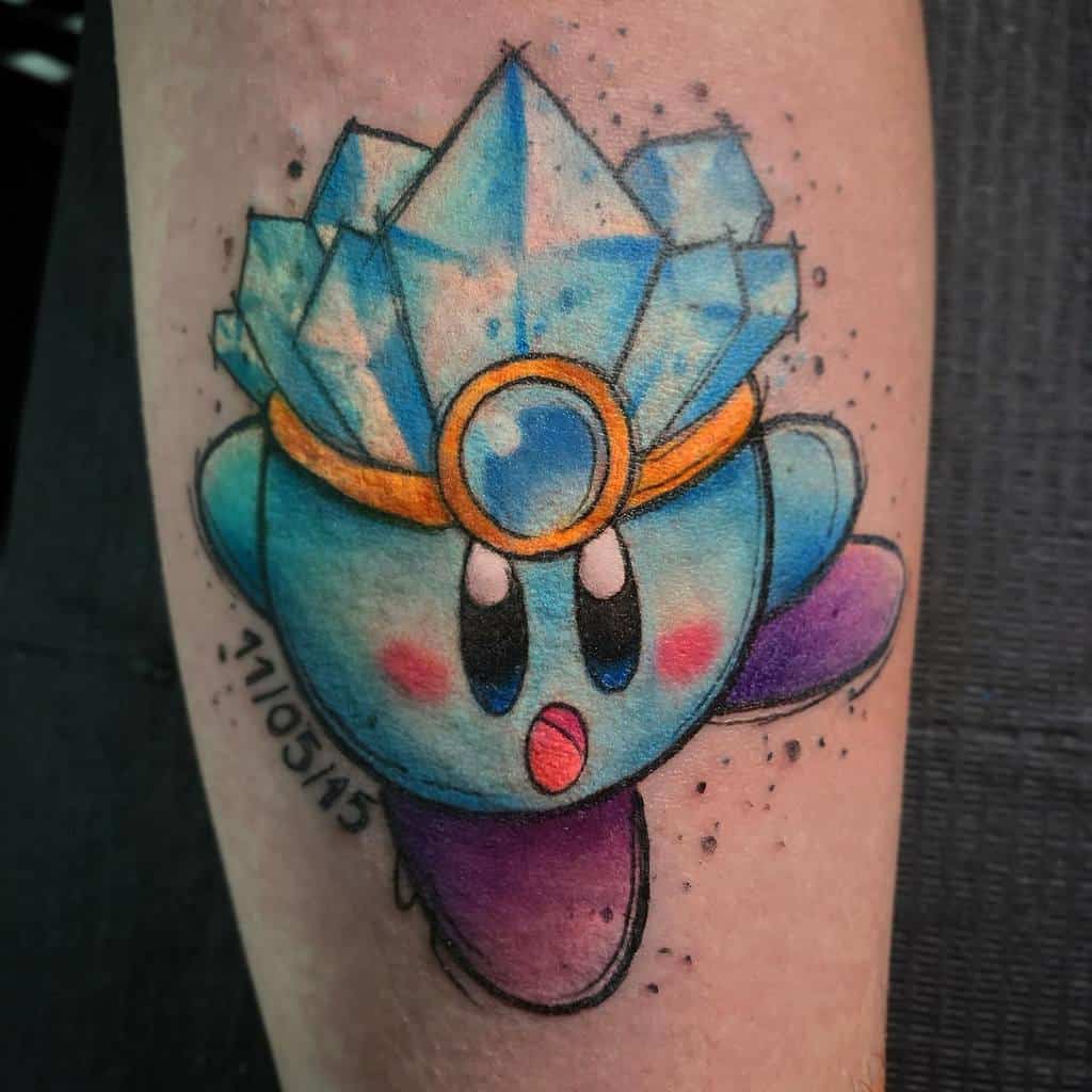 Kirby tattoo in ice form with a crystal crown, jeweled headpiece, and the date 11/05/15 on the side