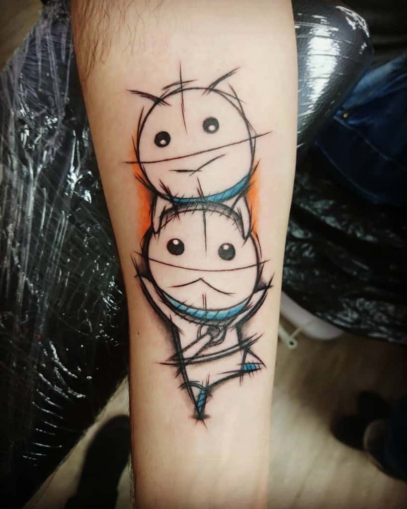This tattoo has a sketch-style design with two stacked round figures, accented with blue and orange. What inspired this unique choice?