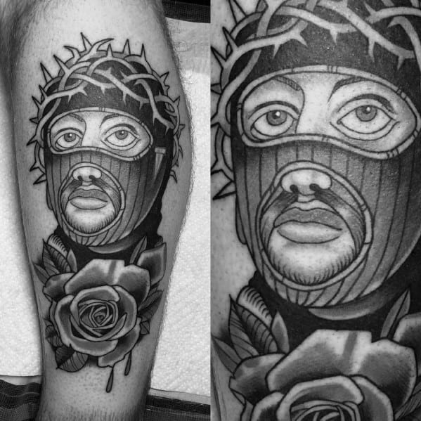 Tattoo of a man in a ski mask with a crown of thorns and a detailed rose below, blending religious and urban symbolism.