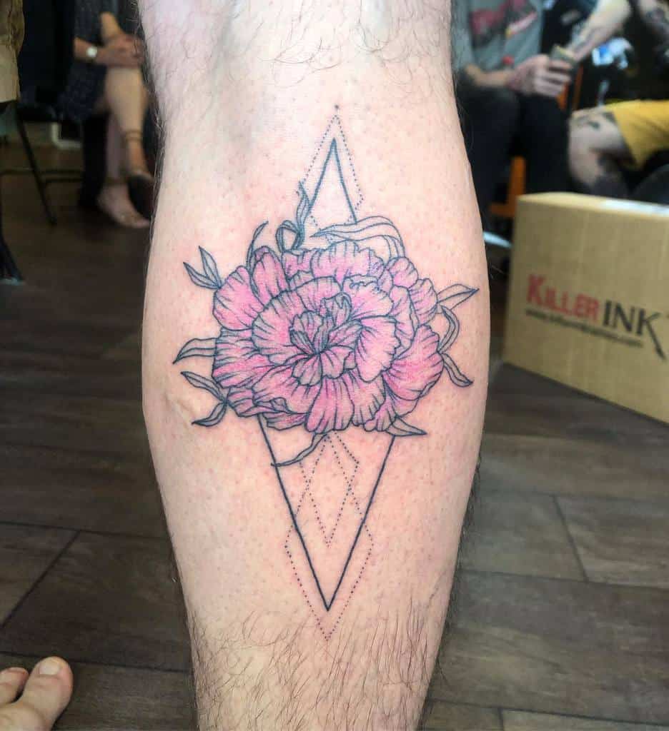 Tattoo of a pink carnation with a geometric diamond outline in black ink