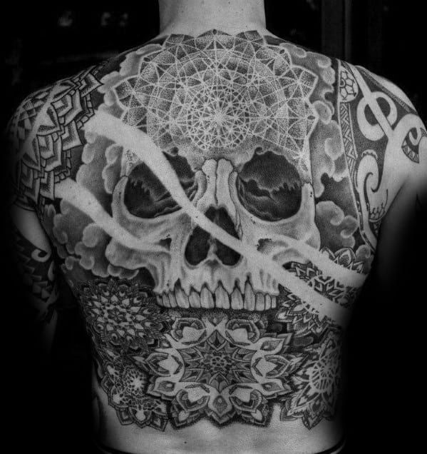 Geometric skull back tattoo with intricate mandala patterns, sacred geometry, and layered shading blending symmetry with macabre beauty.