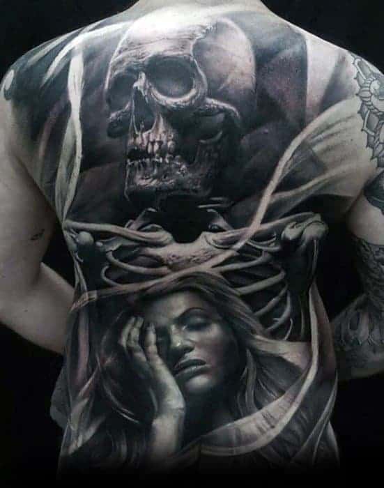 A tattoo of a skull and a sad woman on a person's back