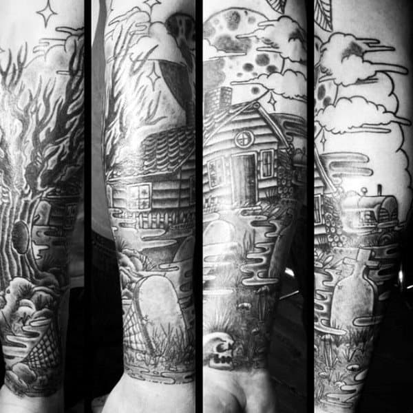 Black and white tattoos of a cabin in nature with a river, tree, clouds, and subtle graveyard in the background on forearms