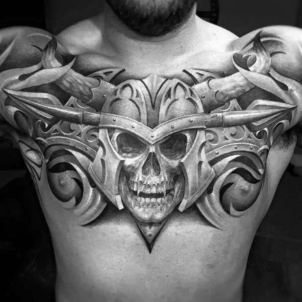 Armored skull chest tattoo with 3D effect and horned helmet, symbolizing warrior spirit, fearlessness, and a battle-hardened soul.
