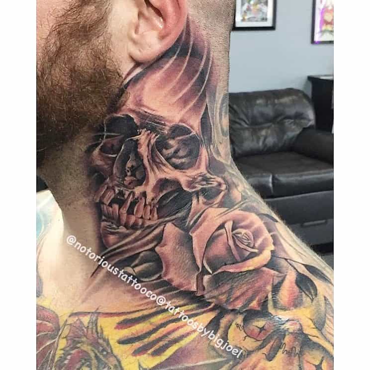 Skull and rose tattoo on a man's neck and part of his shoulder