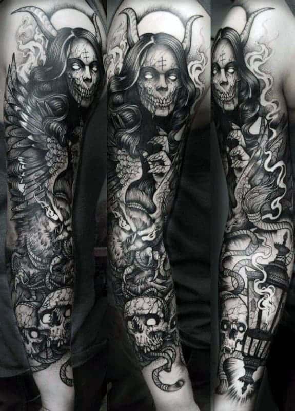 Full-sleeve tattoo with demonic and skull designs, including snakes and intricate details