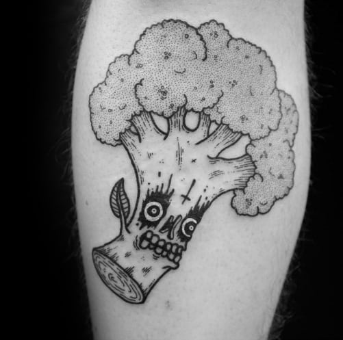Black ink broccoli tattoo with a skull face, featuring fine dot work and bold outlines for a dark yet creative design.