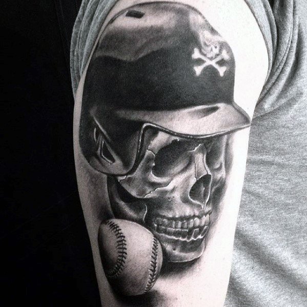 Black and grey tattoo of a skull wearing a baseball helmet with a skull-and-crossbones emblem, paired with a realistic baseball underneath.