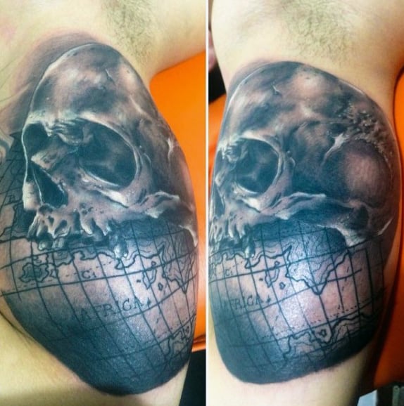 Skull With Globe Map Tattoo On Mans Bicep