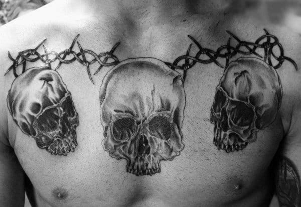 Skulls And Barbed Wire Mens Chest Tattoo Design Ideas