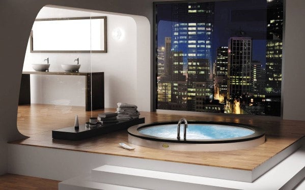 Modern bathroom with a round hot tub and a cityscape view from the window