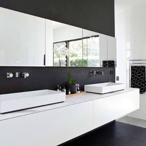 Modern black and white bathroom with floating vanity, dual vessel sinks, and mirrored cabinets.