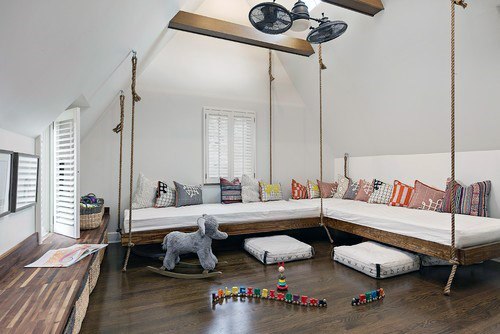 Playful kids' bonus room with hanging daybeds and vibrant cushions.