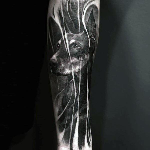 Realistic black and grey Doberman tattoo with abstract white streaks flowing across the design, creating a dynamic and ethereal effect.