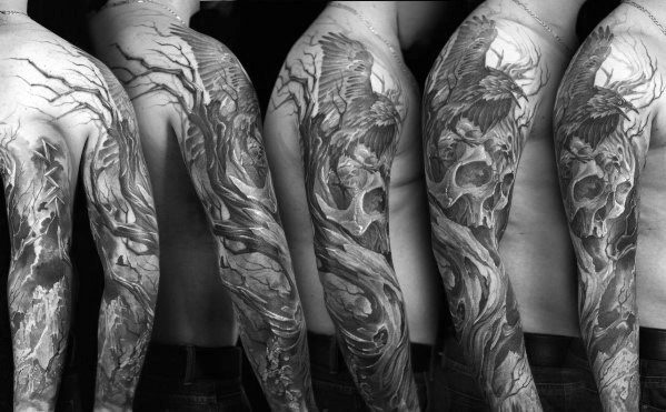 Full sleeve tattoo with ravens, skulls, and gnarled trees in a dark forest scene, showcasing detailed black and grey realism.