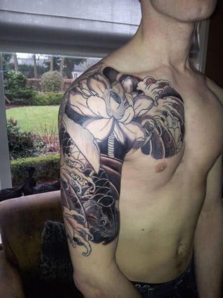 Intricate black and white arm and shoulder tattoo