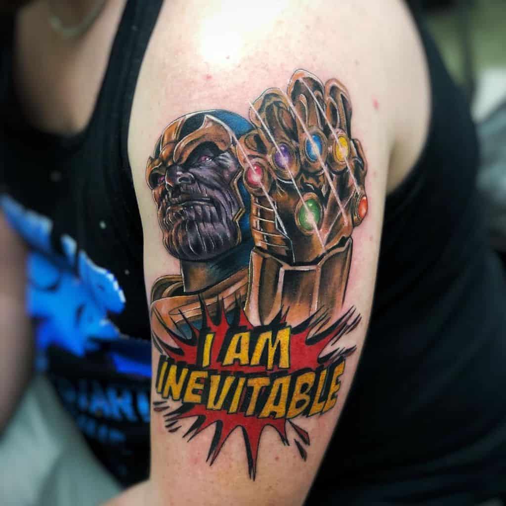 A colorful tattoo of Thanos with the Infinity Gauntlet, accompanied by the bold phrase "I AM INEVITABLE," set in a comic-style burst of color