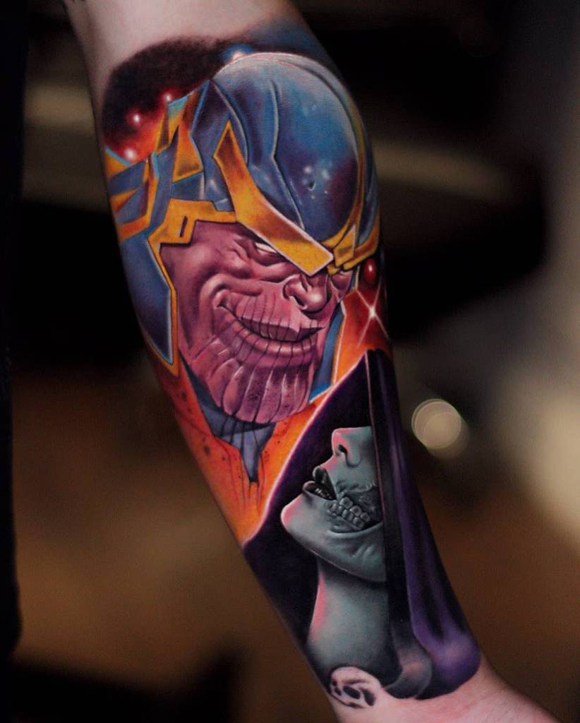 A colorful tattoo of Thanos with a menacing grin, surrounded by space elements, and featuring a vivid portrait of Gamora in the design