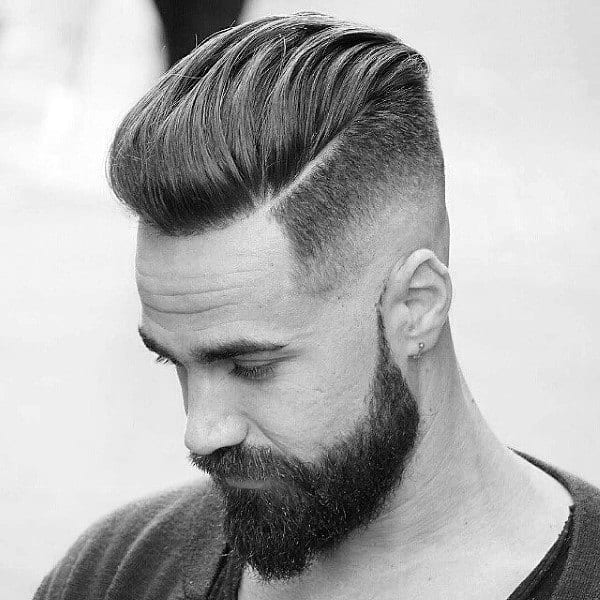 Slicked Back Wavy Mens Skin Fade Hairstyle