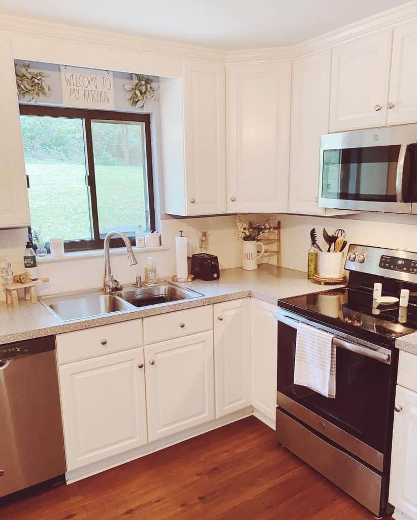 kitchen with white cabinets and brown sliding window