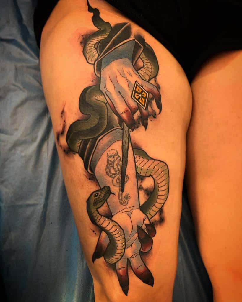 Dark Harry Potter tattoo featuring a sinister hand holding a wand, a coiling snake, a diamond ring and the Dark Mark.