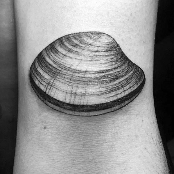 Minimalist clam shell tattoo with fine line detailing and subtle shading, creating a soft, realistic effect on the skin.