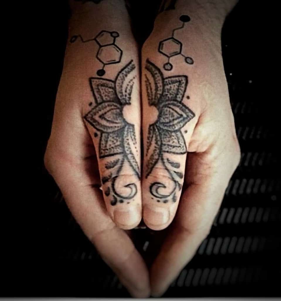 Mandala-style tattoo on fingers with serotonin molecules on both hands, creating a symmetrical design