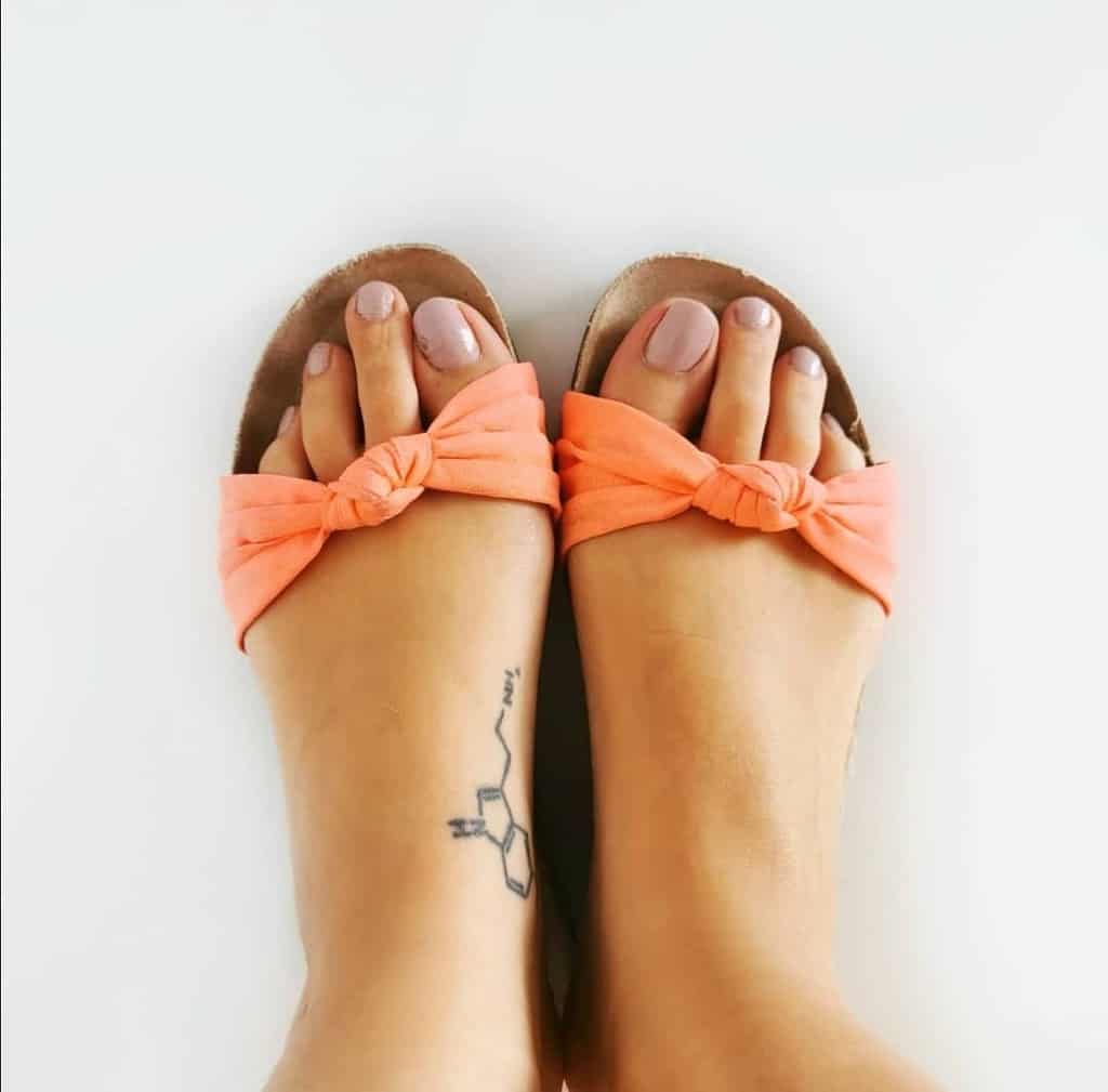 Simple serotonin molecule tattoo on the side of the foot