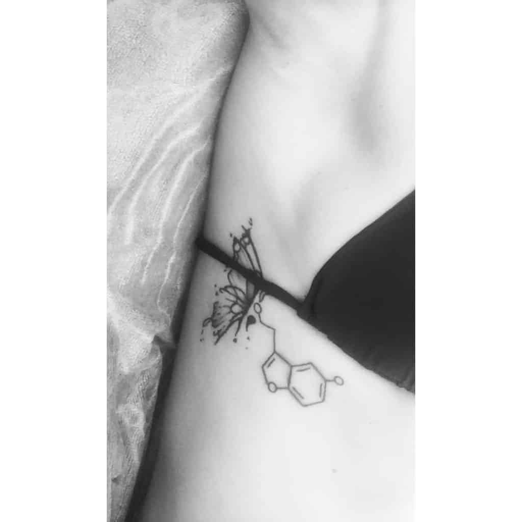 Serotonin molecule tattoo on the side with a butterfly and semicolon