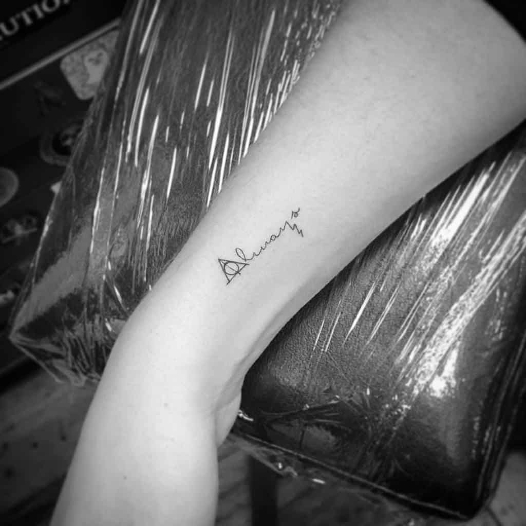 Simple forearm tattoo featuring 'Always' in cursive with the Deathly Hallows symbol, inspired by Harry Potter's timeless quote.
