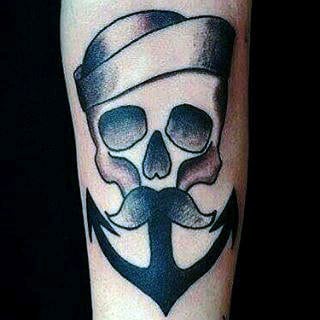 Tattoo of a skull with a sailor hat and an anchor-shaped mustache