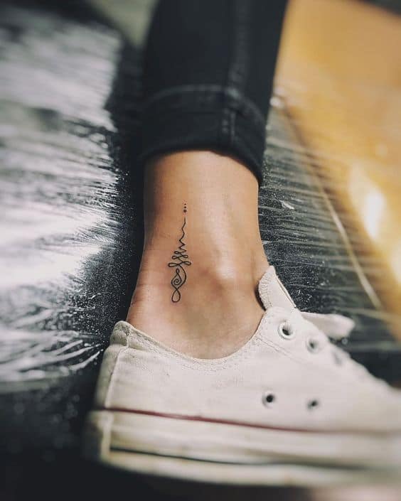 Delicate Unalome tattoo on the ankle, featuring a flowing line with loops and dots, symbolizing life's journey and spiritual growth.