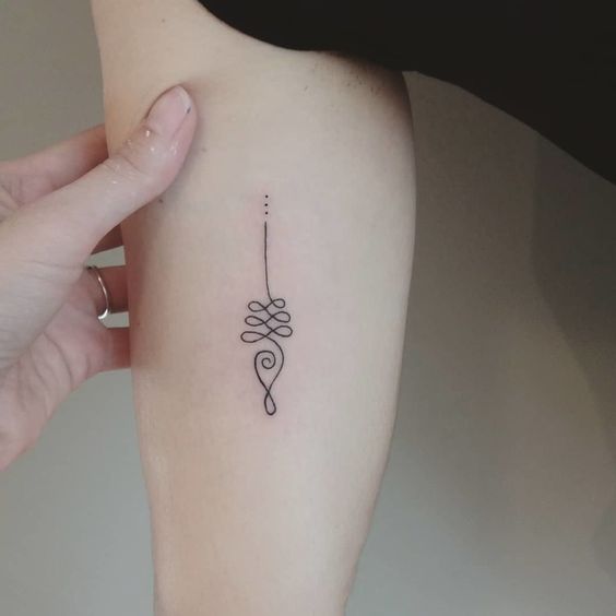 Simple Unalome tattoo on the inner arm, symbolizing life's twists and turns, spiritual growth, and the journey to enlightenment.