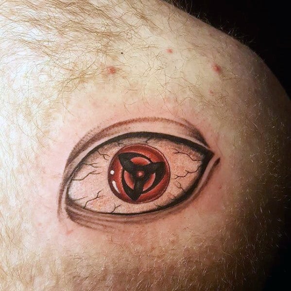 Sharingan tattoo with red iris and intricate black tomoe details, resembling a realistic eye design