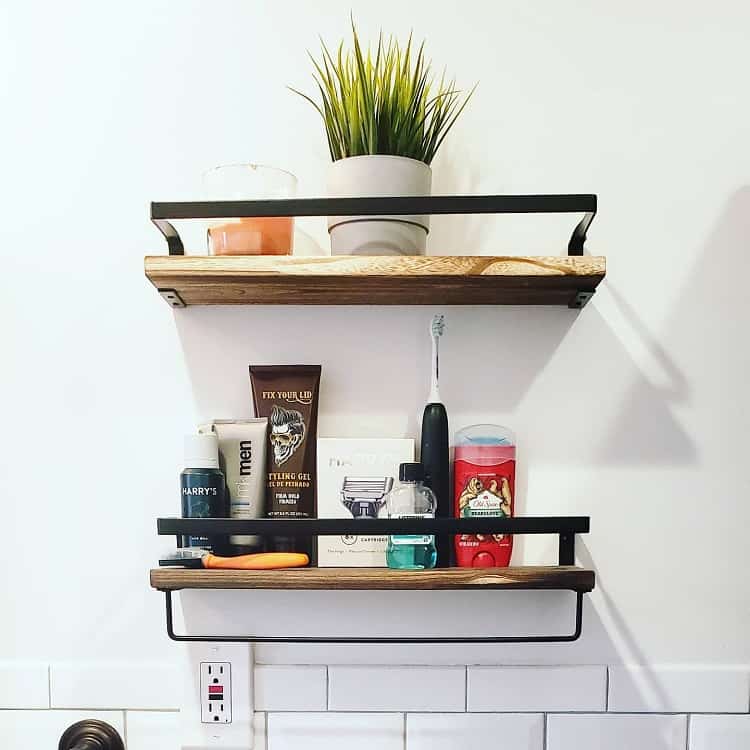 Small bathroom shelf with men's toiletries, electric toothbrush, and a potted plant.