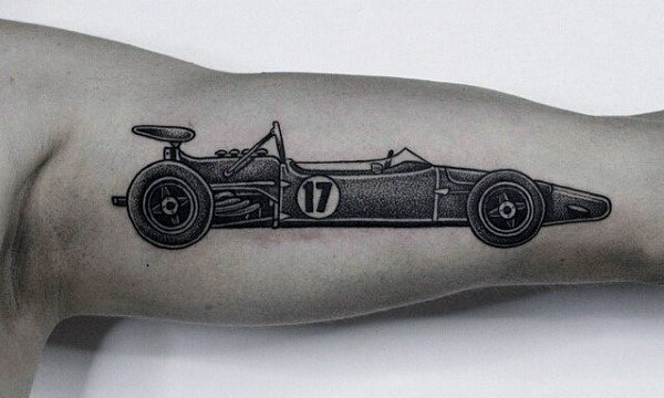 Tattoo of a vintage race car with the number "17" on a bicep