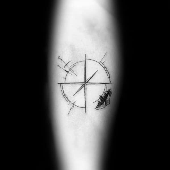 Minimalist compass tattoo with fine-line details and a feather accent, symbolizing direction, freedom, and a light, airy sense of adventure.