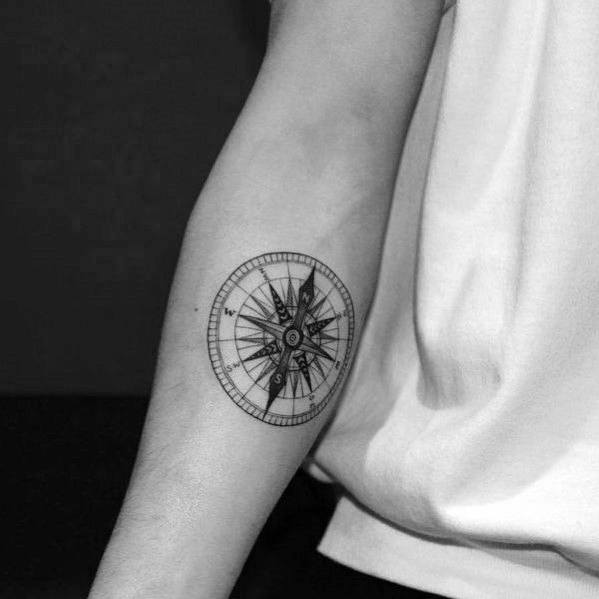 Detailed compass tattoo with fine lines and precise shading, creating a classic and elegant design symbolizing direction and exploration.