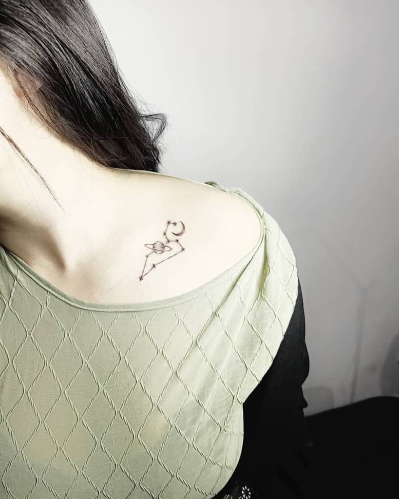 Simple yet stylish Leo tattoo on the upper chest, blending astrological symbolism with geometric artistry.