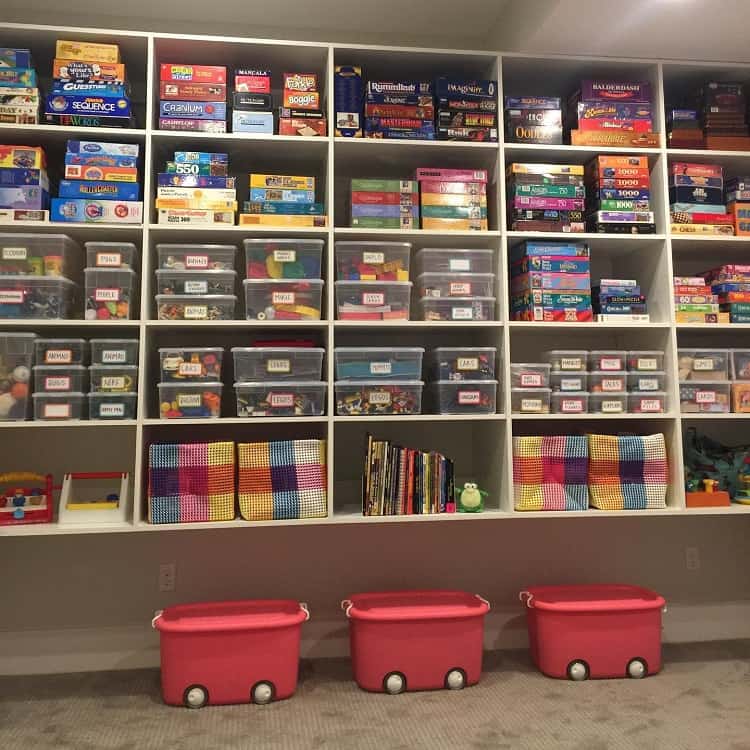 Basement shelves with board games and labeled storage bins for toys and small items.