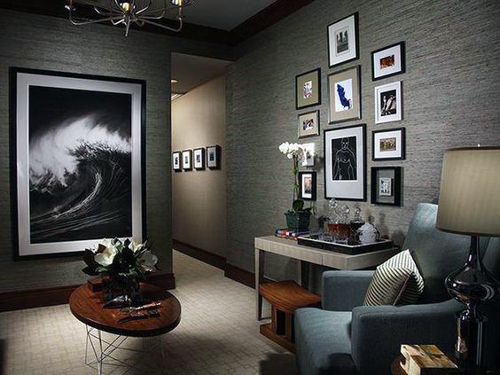 Cozy living room, perfect for a man cave, with a wave photo, gallery wall, armchair, and side table with decor