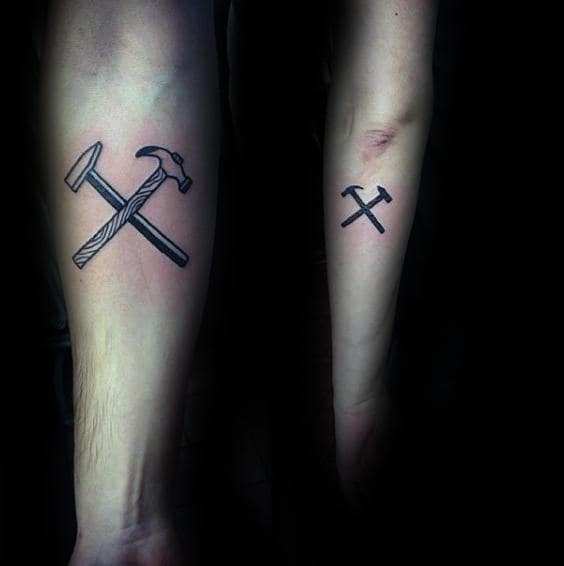 Small Crossed Hammers Male Inner Forearm Tattoo Design Idea Inspiration