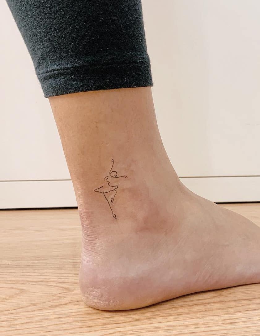 Elegant minimalist ballerina tattoo featuring delicate line art that captures grace and movement.