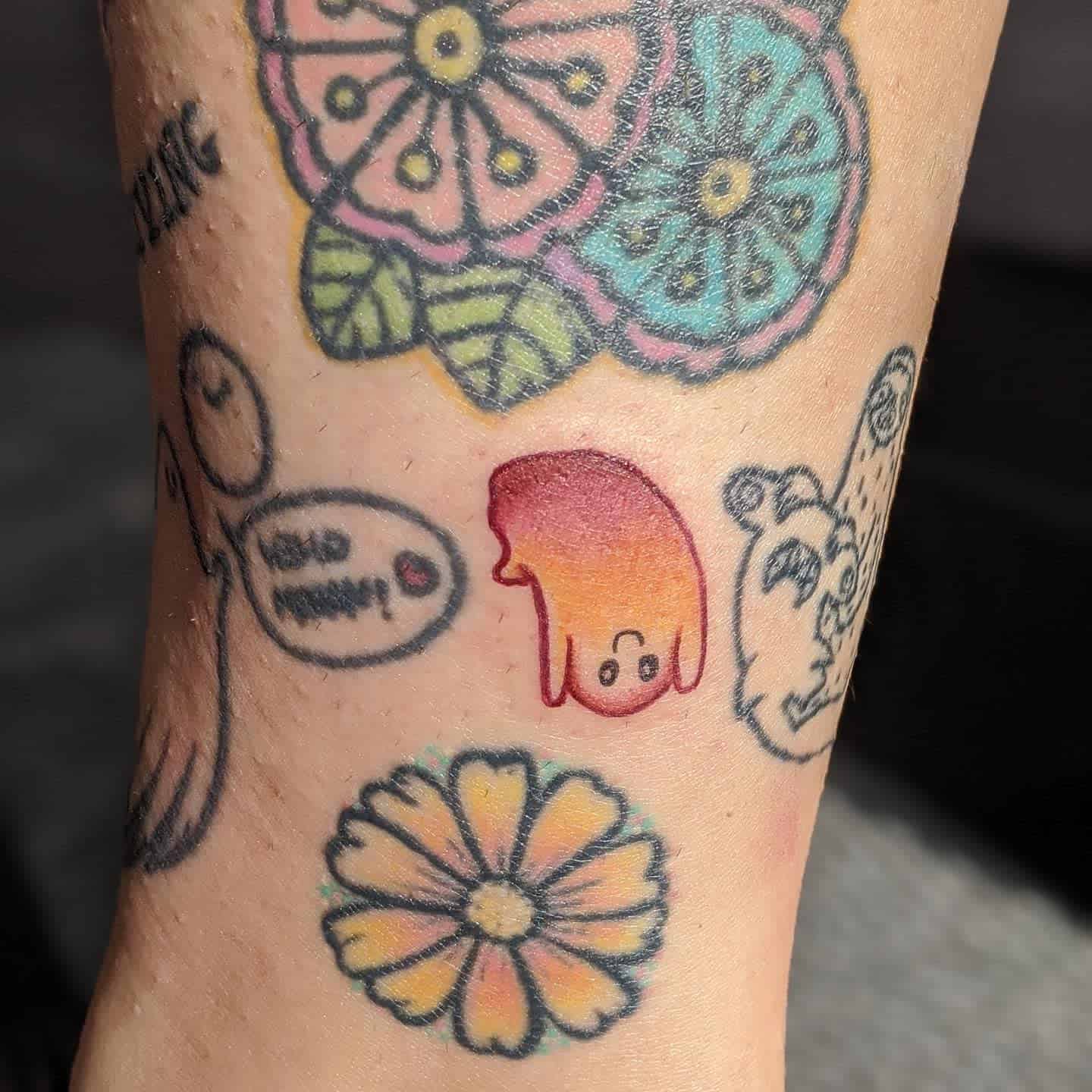 Adorable upside-down ghost tattoo with a gradient of warm colors