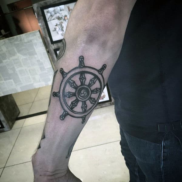 Small Dharma Wheel Outer Forearm Tattoo On Man